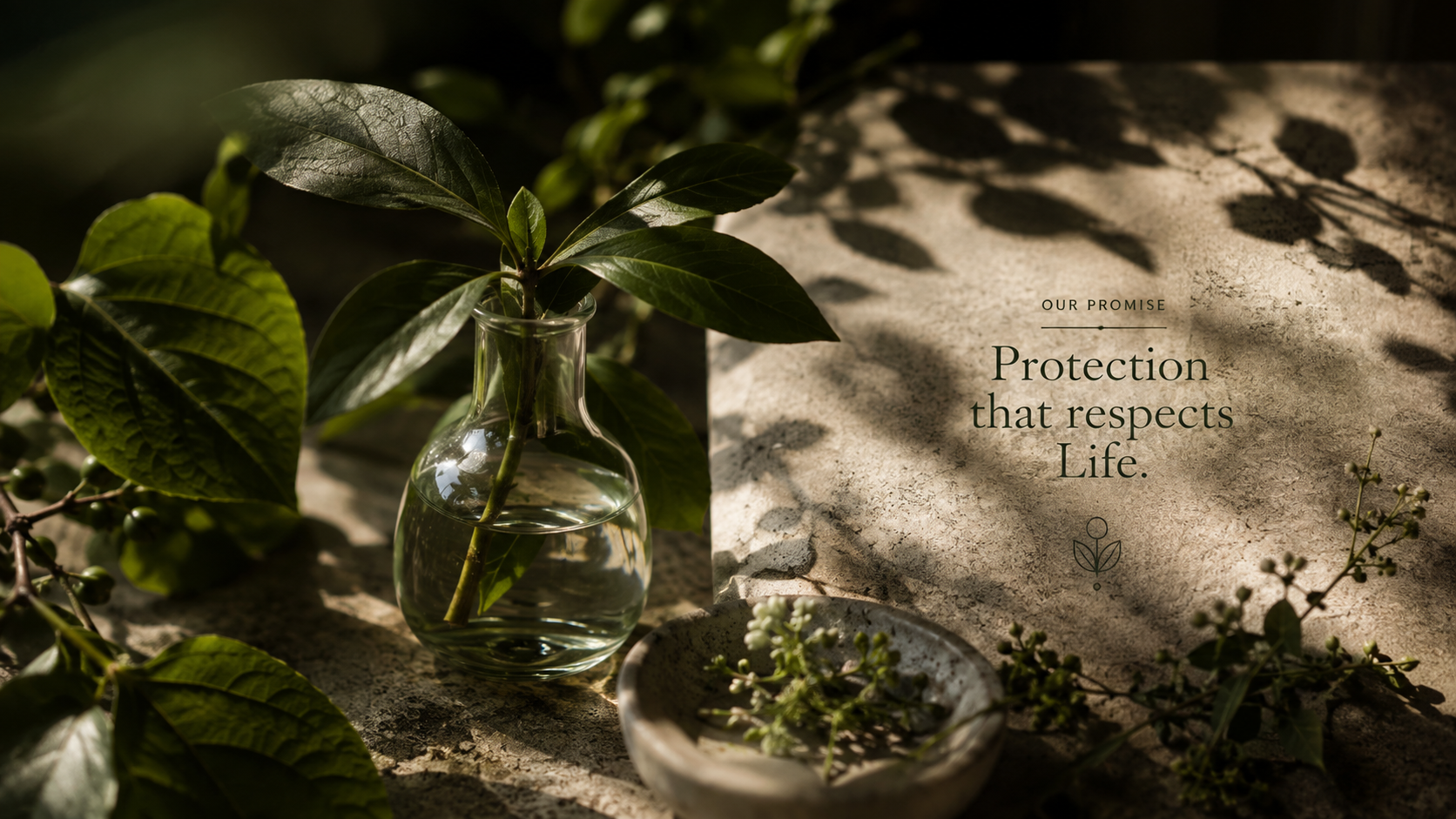 Botanical cutting in glassware beside engraved stone promise slab
